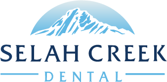 Logo for Selah Creek Dental featuring a stylized blue mountain range above the name. “SELAH CREEK” appears in large dark blue capital letters, with “DENTAL” in smaller light blue capitals below, flanked by horizontal lines.